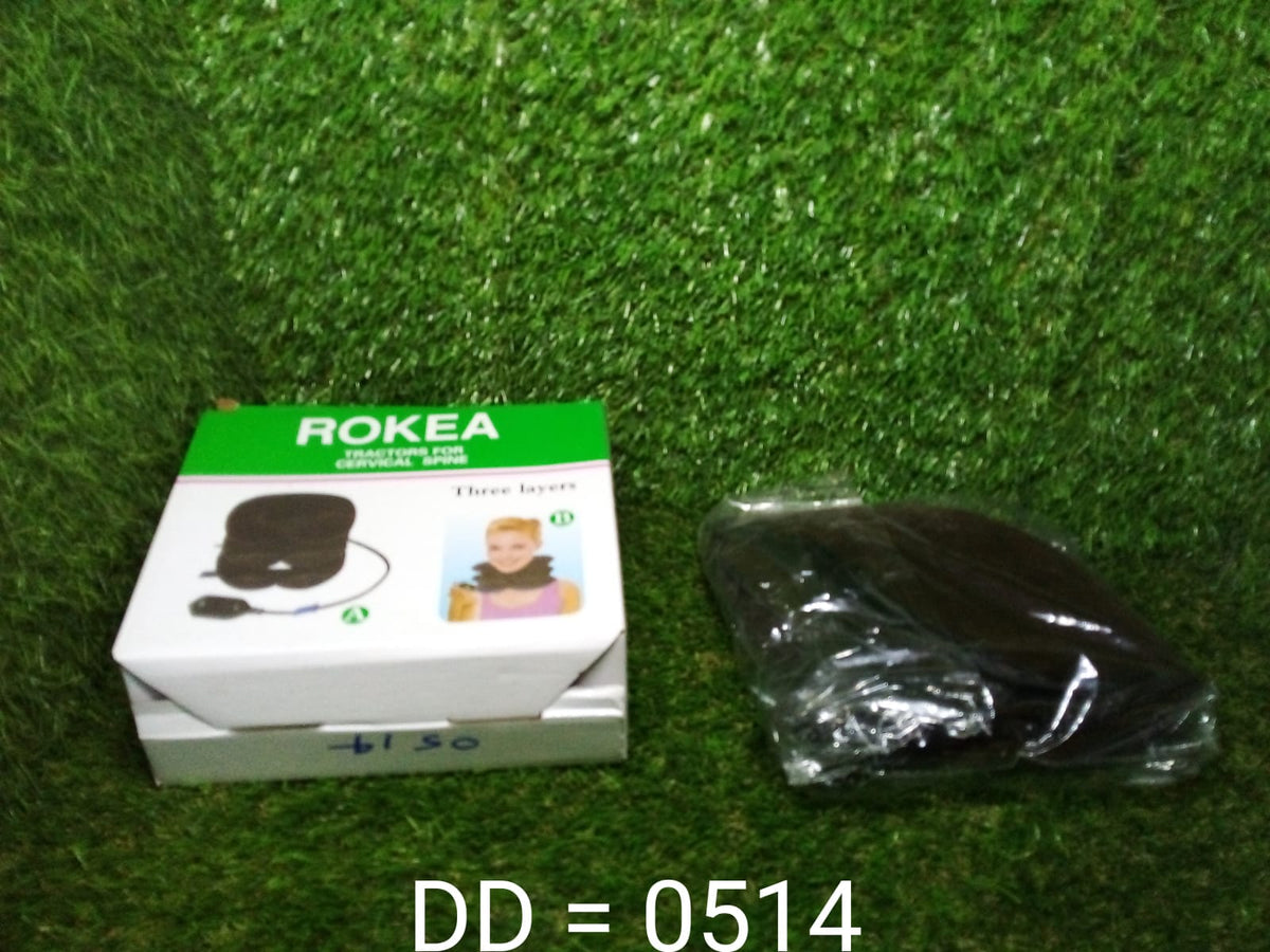 A white box for a "ROKEA" three-layer cervical spine traction device and a black plastic-wrapped device on green turf.