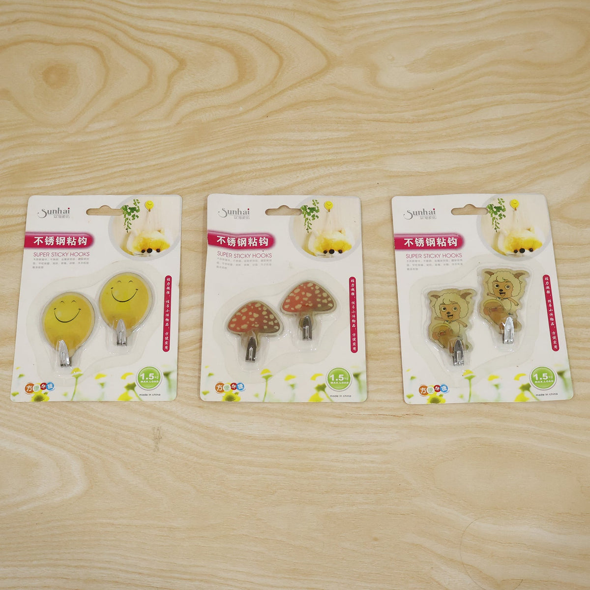 Packaged cartoon animal self-adhesive wall hooks, as seen in retail packaging.