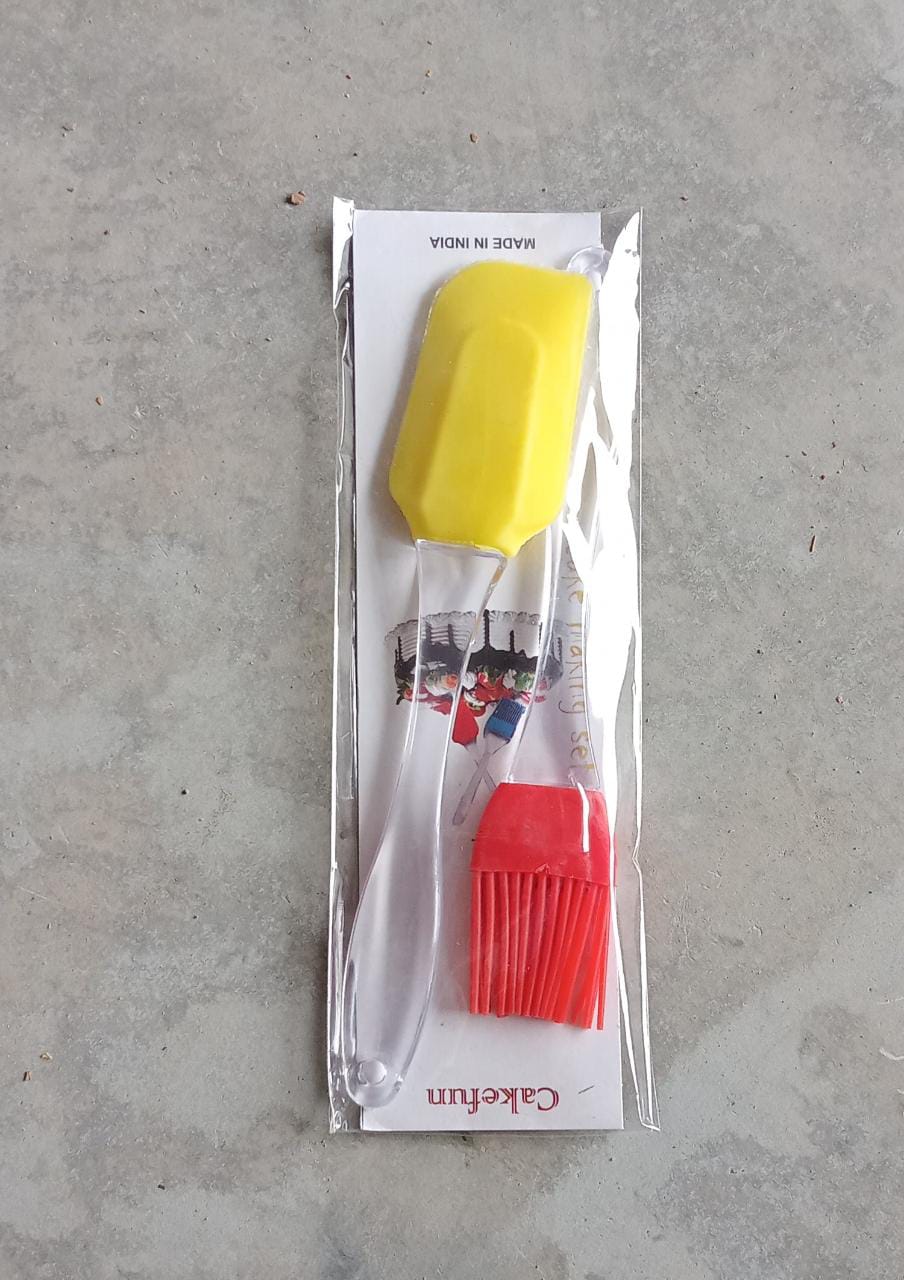 A yellow silicone spatula and a red silicone pastry brush are sealed in clear plastic, explicitly marked 'Made in India'.