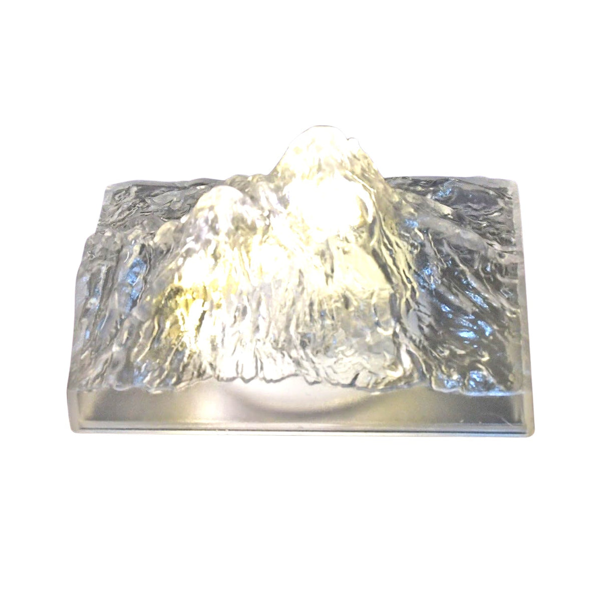 A clear, textured iceberg-shaped LED light glows warmly against a plain white background.