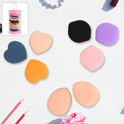 Eight mini makeup sponges in assorted colors and shapes on a light background with a pink tube inset.