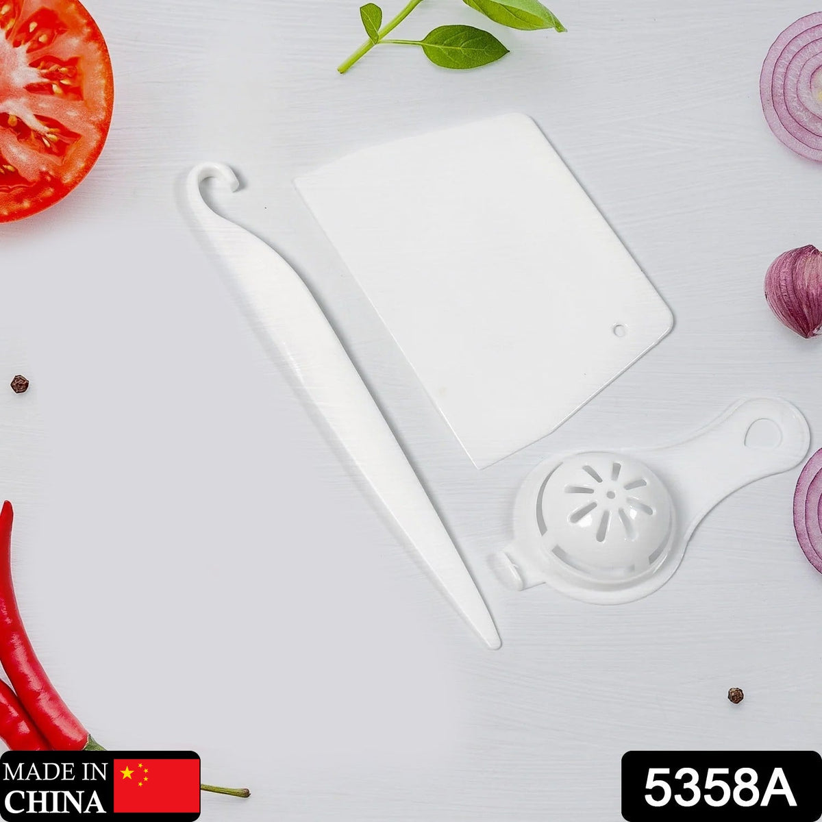 Three white plastic baking tools, including a scraper, a curved tool, and an egg separator, are arranged on a white surface.