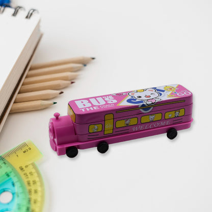 Pink bus pencil case with a cartoon bear design, next to a notebook and pencils on a white desk.