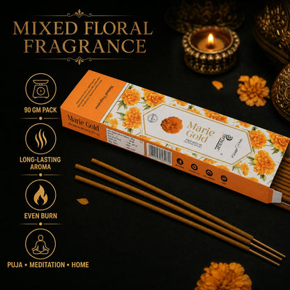 An open orange box of Marie Gold incense sticks with three sticks in front, surrounded by marigolds.