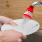 Compact plastic 360-Degree Shower Head attached to a tap, showing its flexible design.