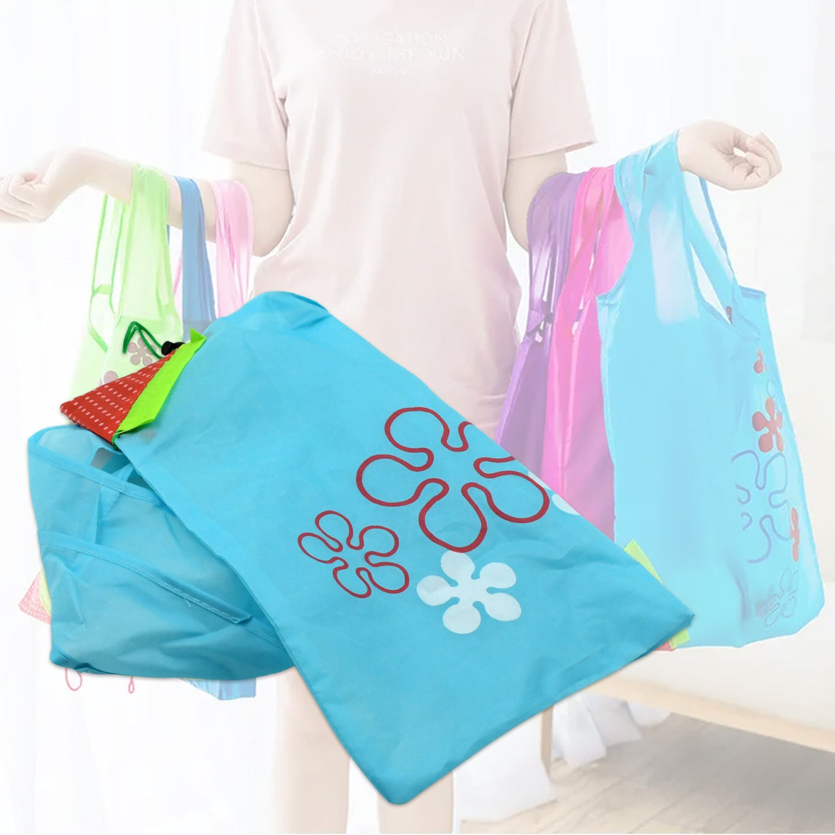 A light blue reusable shopping bag with flower designs in the foreground, with blurred figures holding colorful bags in the