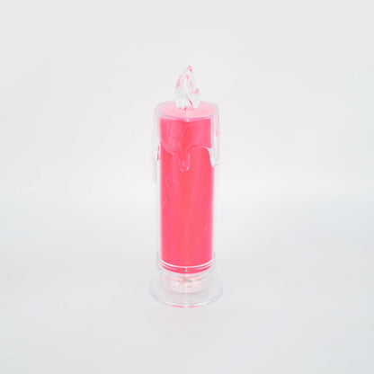 A pink LED glitter candle with a clear base and flame-shaped top, unlit against a white background.