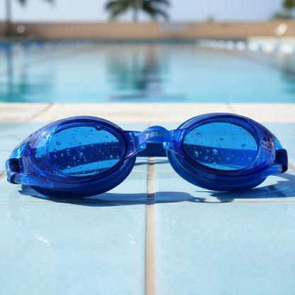 A two-piece set of swimming goggles, one black and one blue, sealed in clear plastic packaging with a blue and white backing