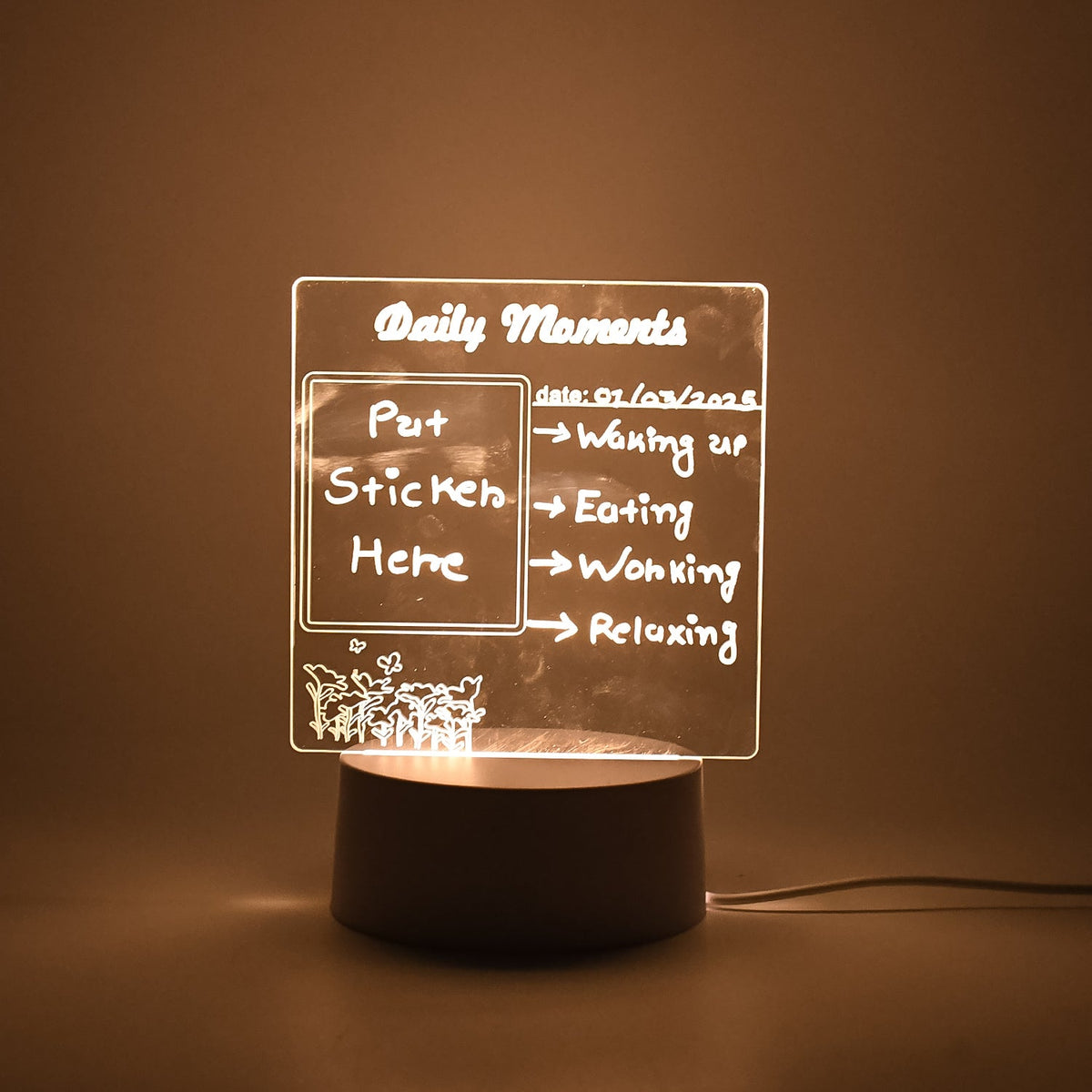 A softly glowing acrylic message board lamp on a dark surface, displaying a daily schedule.