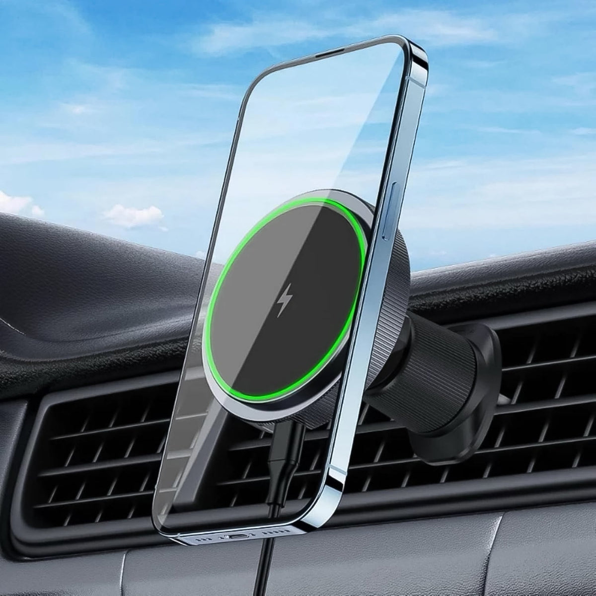 A smartphone magnetically attached to a black wireless car charger with a green glowing ring, mounted on a car's air vent.