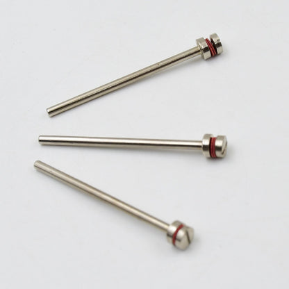 Three silver mandrels with red bands and screw heads lie scattered on a plain white background.