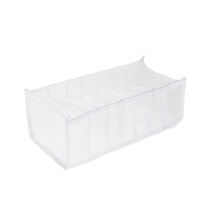 An empty white mesh organizer with seven clear compartments is displayed on a plain white background.