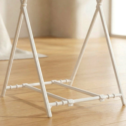 Close-up view of the white plastic base and connecting pieces of the bag holder on wood flooring.
