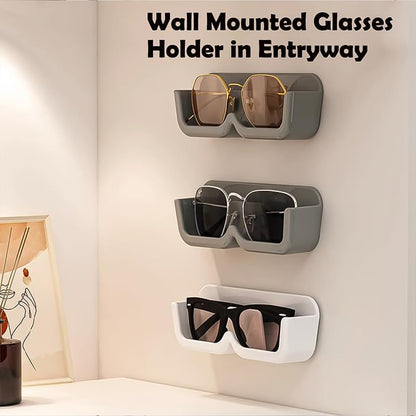Three wall-mounted glasses holders, two gray and one white, holding various glasses in an entryway.
