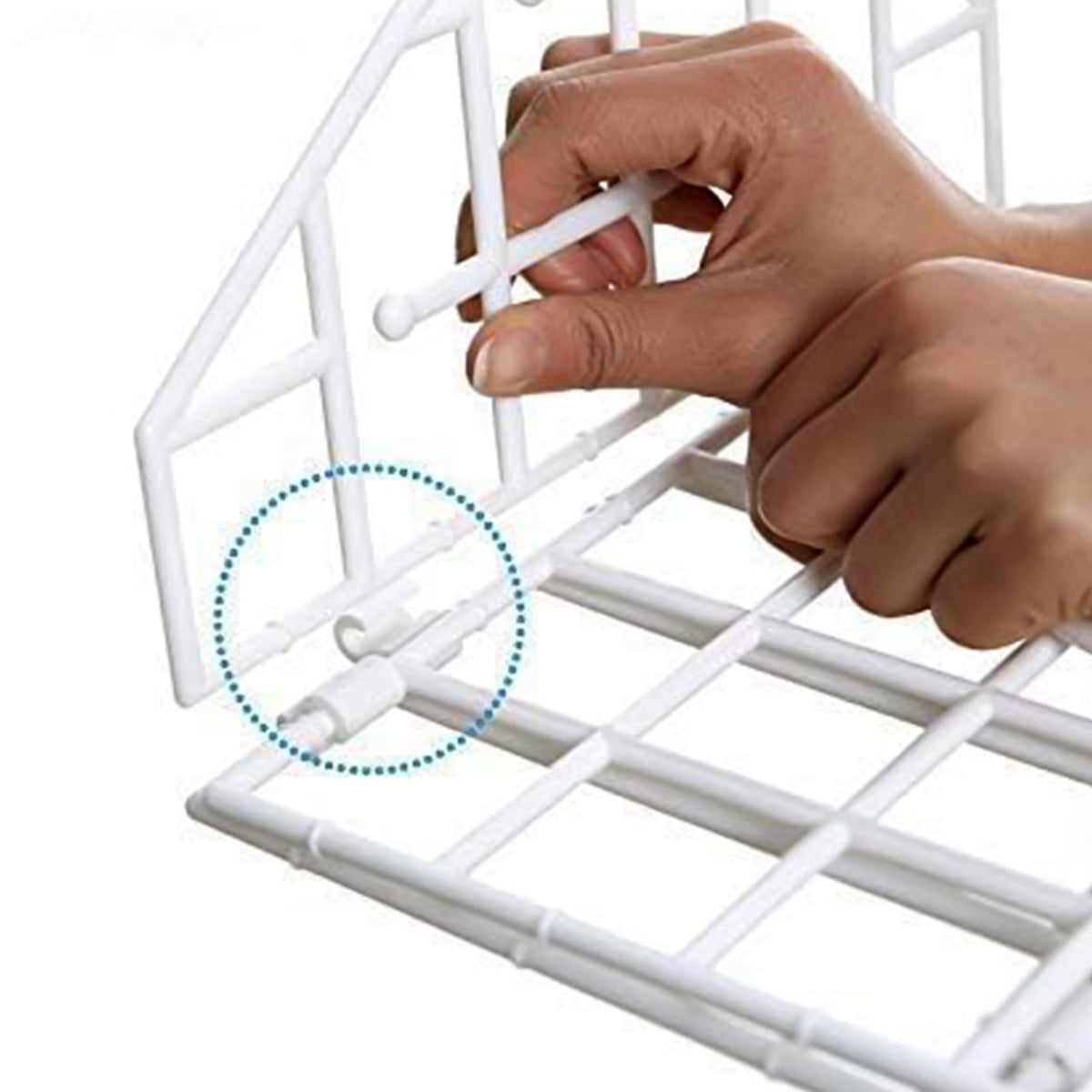 Close-up of hands assembling the white plastic grid pieces of the hanging closet organizer.