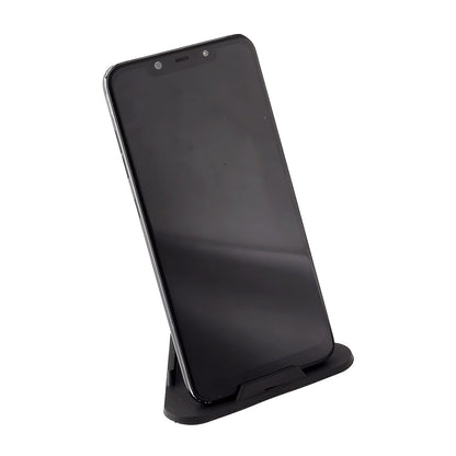 A black smartphone stands vertically on a black pyramid-shaped mobile stand against a white background.