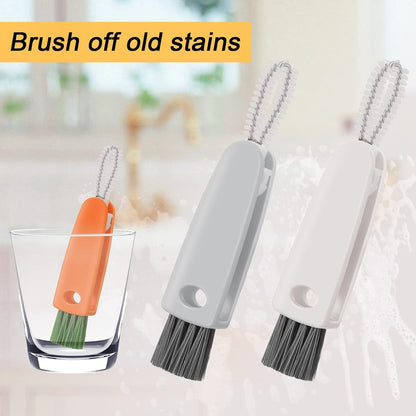 Three 3-in-1 cleaning brushes, one orange and two grey, are shown with one orange brush in a glass of water.
