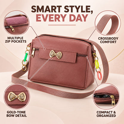 A mauve sling bag with a gold bow and colorful charms, highlighting multiple zip pockets and crossbody comfort.
