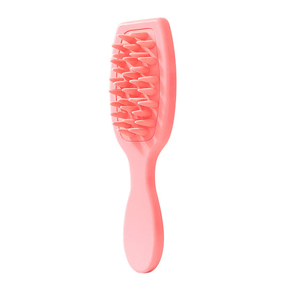 A full view of the pink silicone scalp massager brush on a white background.