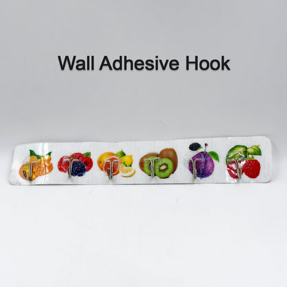 A white adhesive wall hook strip with fruit designs is centered on a plain white background with the text "Wall Adhesive