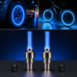 Two blue LED valve cap lights with a car and bicycle showing blue glowing wheels in the background.