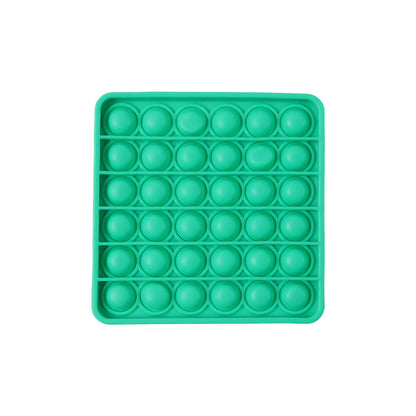 A standalone image of a square green silicone pop-it fidget toy on a white background.