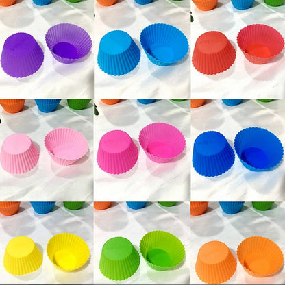 A grid of nine pairs of silicone cupcake molds in various colors like purple, blue, pink, and yellow.
