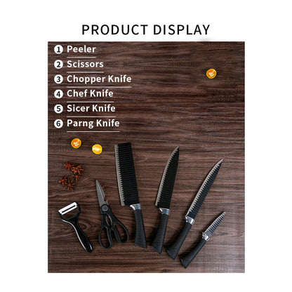 Overhead view of a six-piece black serrated knife set with peeler and scissors on a wooden surface.