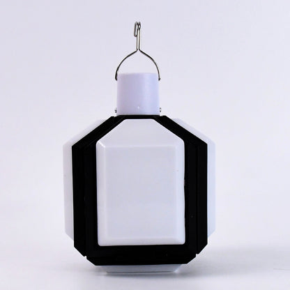 Compact white and black foldable LED lantern with a metal hook on a plain white background.
