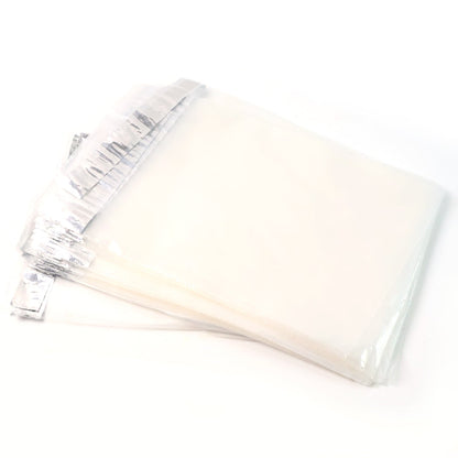 A stack of clear polybags with silver adhesive strips, on a white background.