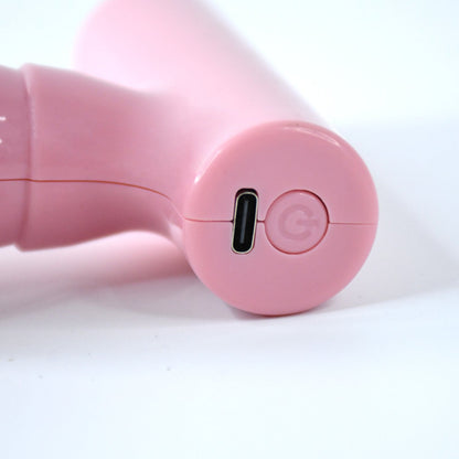 Close-up of the black mini massager's vibrating head, designed for effective muscle relief.