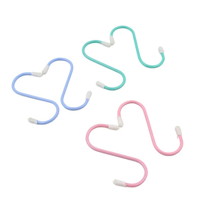 Three colorful plastic coated S hooks in blue, green, and pink on a white background.
