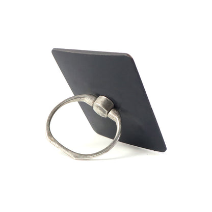 A black square phone ring stand with a silver ring, viewed from an angle, on a white background.
