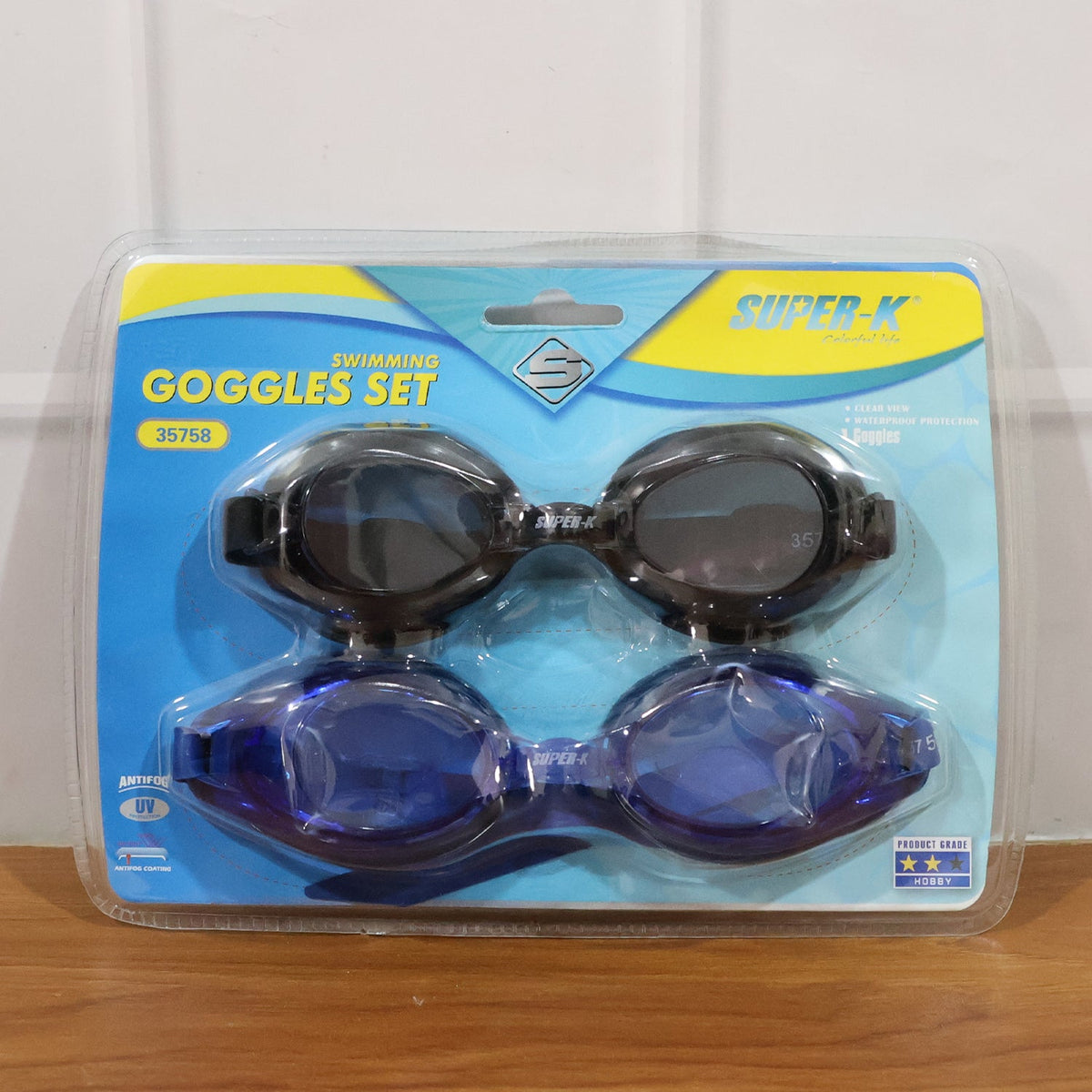 A split image showing a couple in a pool wearing goggles on the left, and a black and blue pair of goggles on a textured