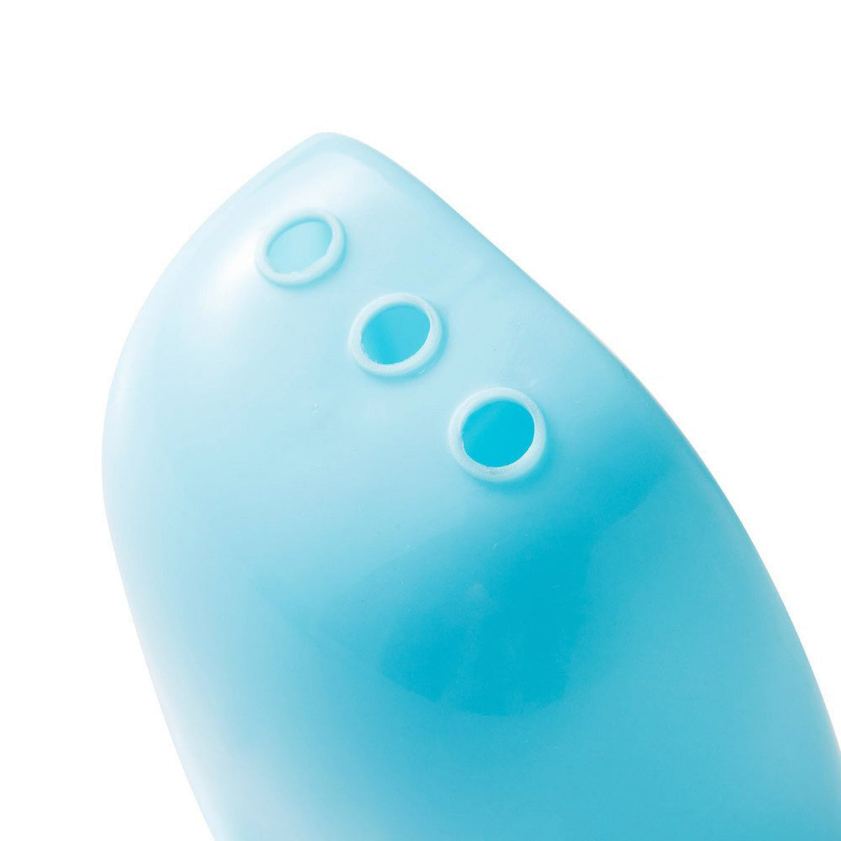 Close-up of the bottom of a blue plastic caddy compartment showing three drainage holes.