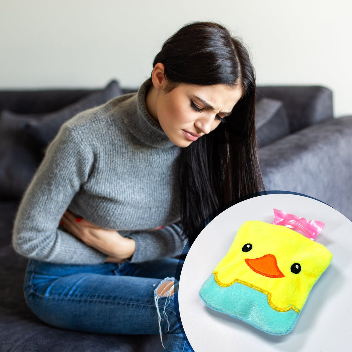 A woman sits on a couch holding her stomach, with an inset of the yellow duck hot water bag.
