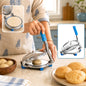 A person uses a stainless steel puri press with blue handle to flatten dough, with finished puris nearby.