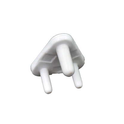 A single white plastic child safety socket cover, triangular with three prongs, viewed from an angle on a white background.