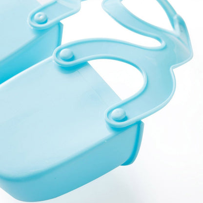 Close-up of the blue plastic caddy's adjustable strap mechanism connecting to a compartment.
