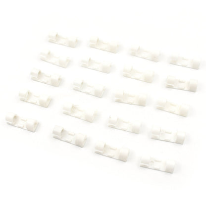 Twenty white plastic cable clips arranged in four rows of five on a clean white background.