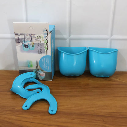 Blue plastic sink caddy components and its packaging box on a wooden surface.