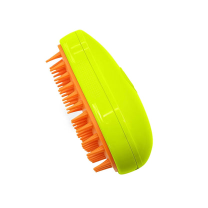 A lime green and orange pet grooming brush with soft bristles is angled on a white background.