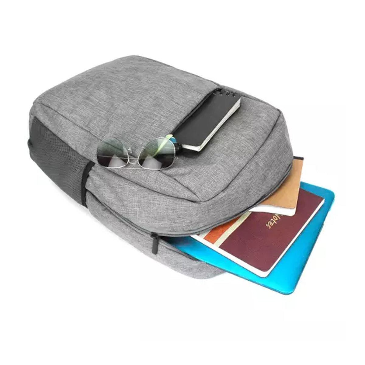 A grey backpack with sunglasses, a notebook, and a blue laptop partially visible from an open compartment.