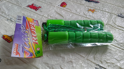 A packaged green electronic counting skipping rope lies next to its colorful box on a textured white surface.