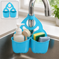 Blue plastic sink caddy holding soap, brush, sponge, and cloth on a stainless steel sink faucet.