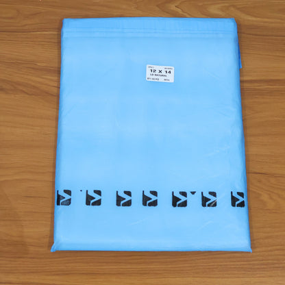 A light blue polybag with black arrow designs and a white label, on a wooden surface.