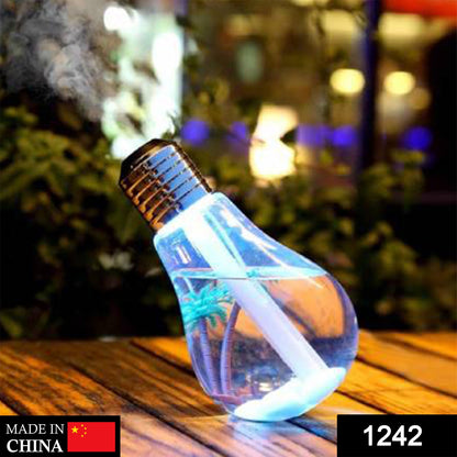 A single blue bulb-shaped humidifier with palm trees inside emits mist on a wooden surface.