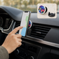 A hand adjusts a phone with a colorful geometric pop socket on a car vent mount, with an inset of the pop socket and mount.