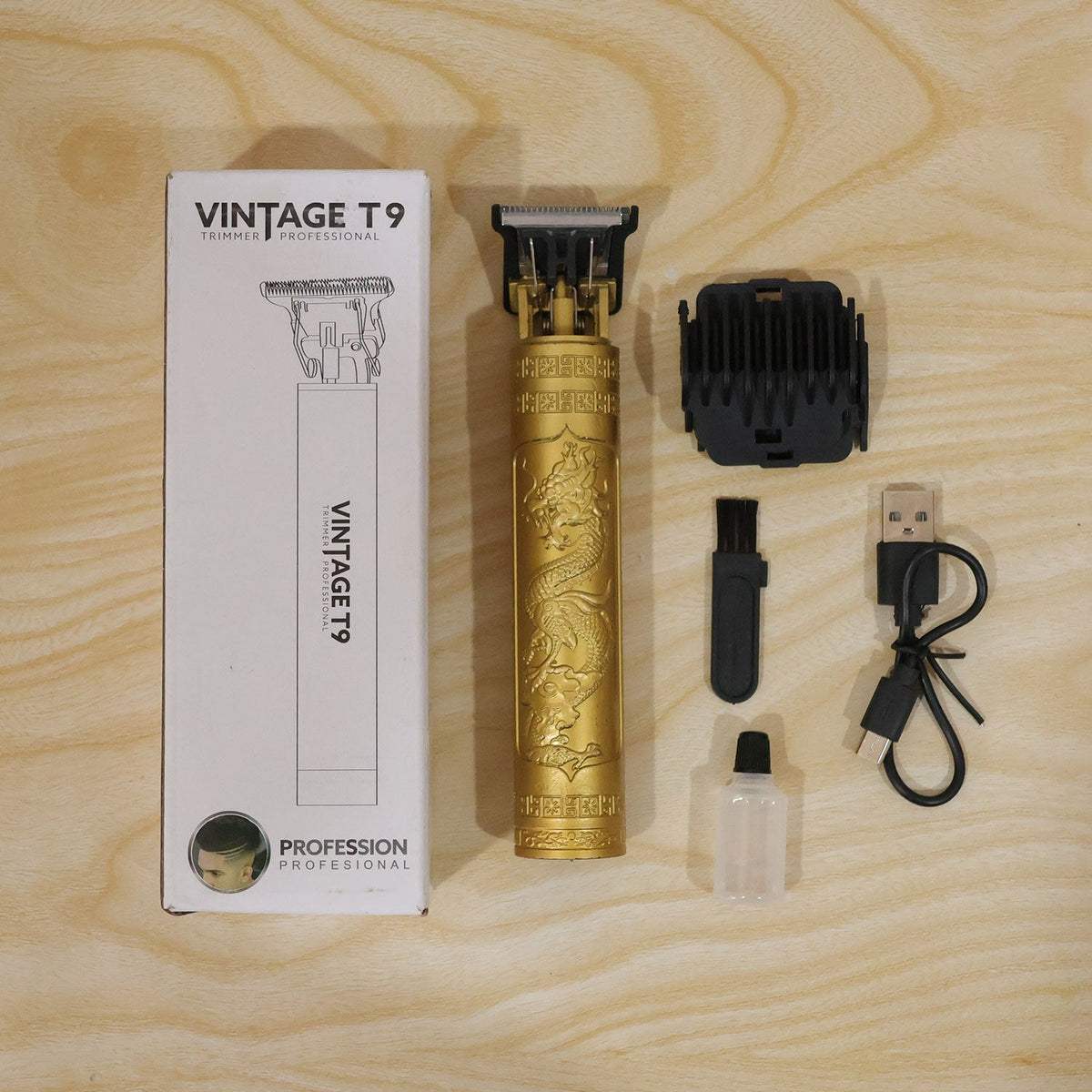 A gold dragon-embossed hair trimmer, guide combs, charging cable, brush, and oil are displayed next to its white