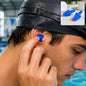 A man in a black swim cap inserts a blue silicone earplug into his ear, with a small inset showing the earplugs.